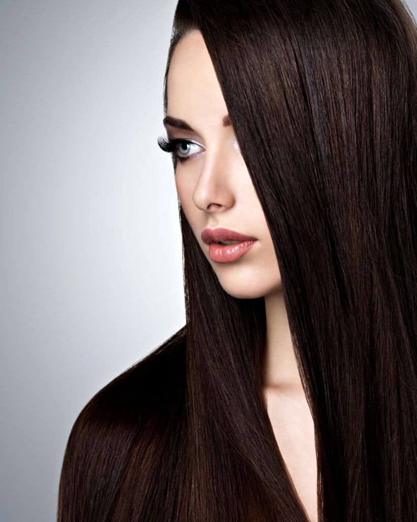 Portrait of beautiful young woman with long straight brown hair